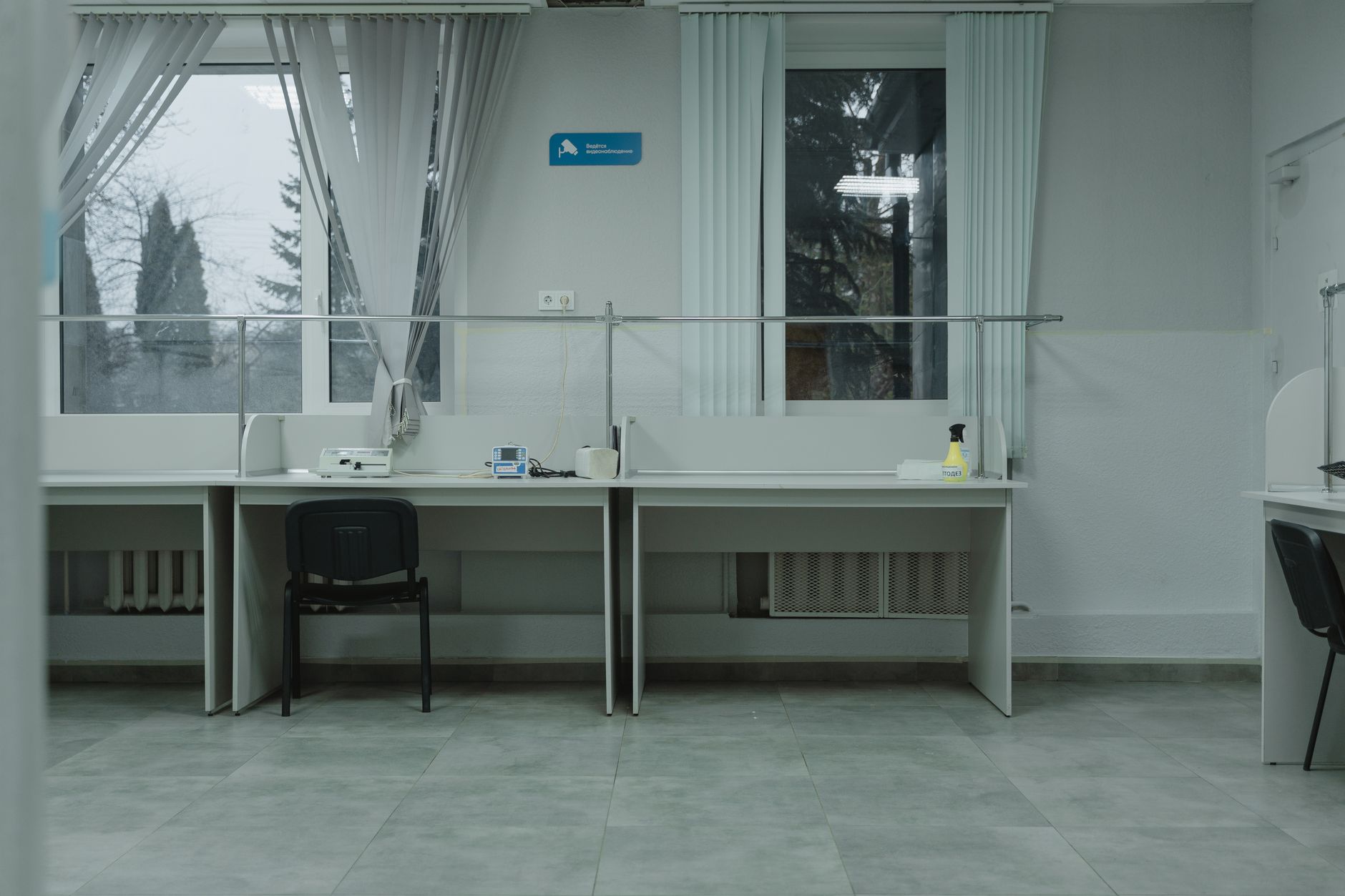 Empty desks by a window in a quiet room
